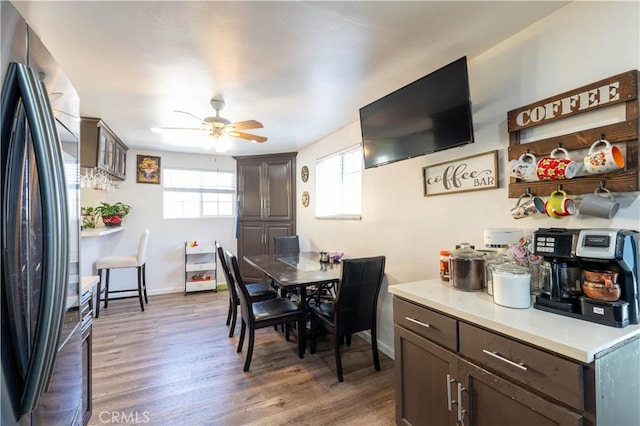 dining room with ceiling fan and dark hardwood / wood-style floors