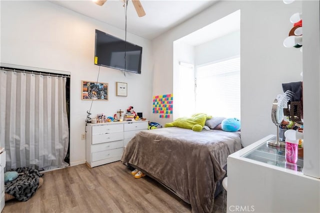 bedroom featuring light wood-type flooring and ceiling fan