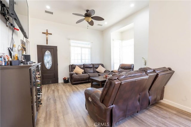 living room with ceiling fan and light hardwood / wood-style floors