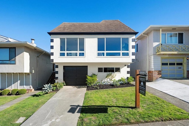 modern home featuring a garage and a front yard