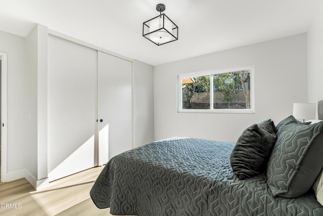 bedroom with a closet and hardwood / wood-style flooring