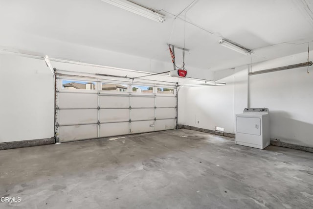 garage featuring washer / clothes dryer and a garage door opener