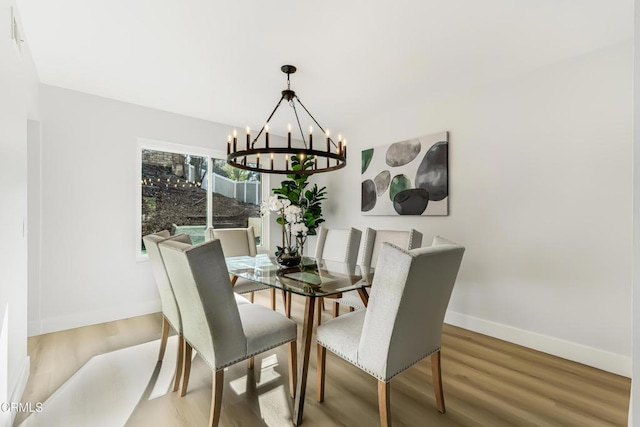 dining room with wood-type flooring and a chandelier