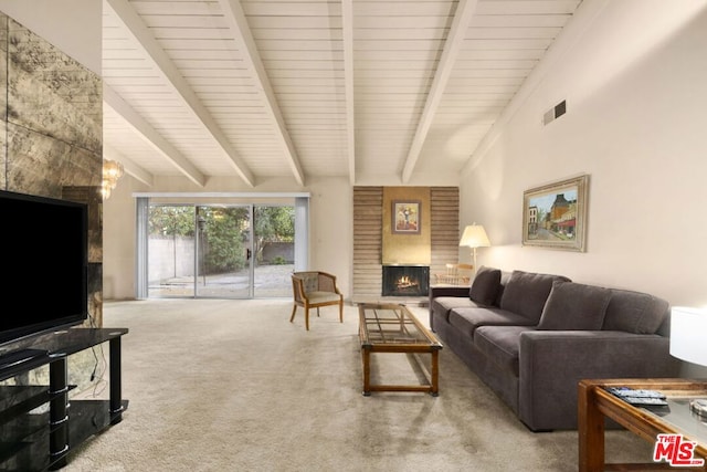 living room with carpet floors, lofted ceiling with beams, and a fireplace