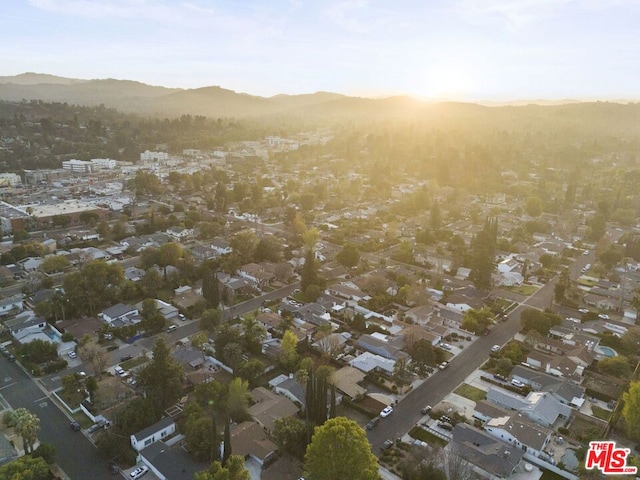 aerial view at dusk featuring a mountain view