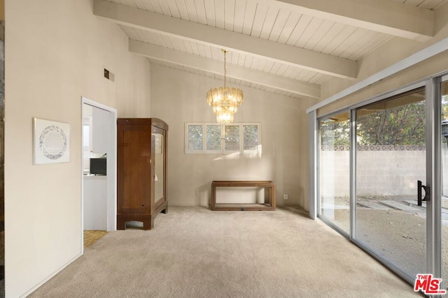 spare room with high vaulted ceiling, beam ceiling, carpet floors, and a notable chandelier