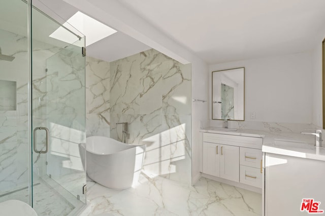 bathroom featuring vanity, a skylight, and shower with separate bathtub