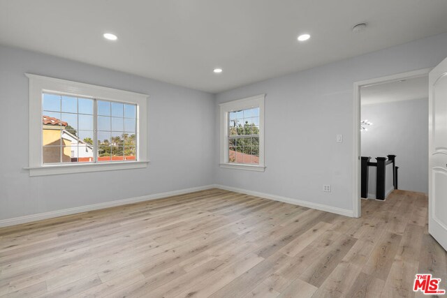 spare room with light hardwood / wood-style flooring