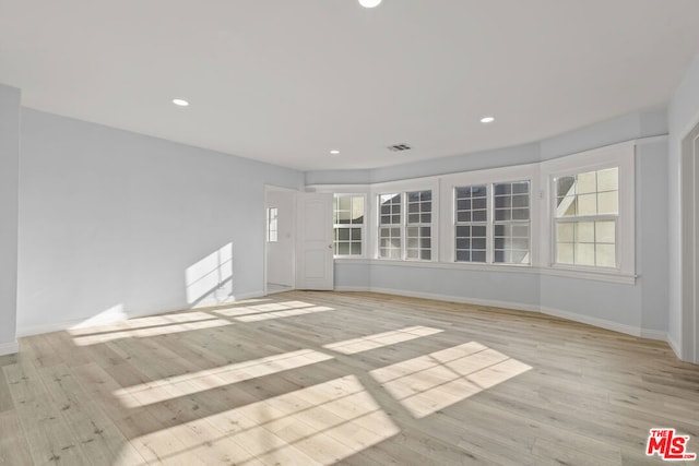 spare room with light wood-type flooring