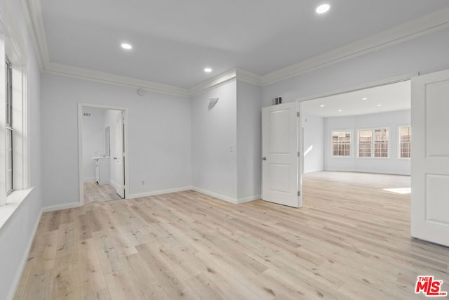 unfurnished room with ornamental molding and light hardwood / wood-style flooring