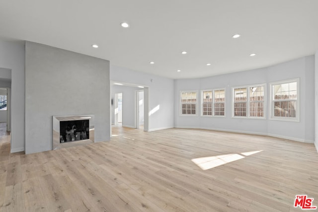 unfurnished living room featuring light wood-type flooring