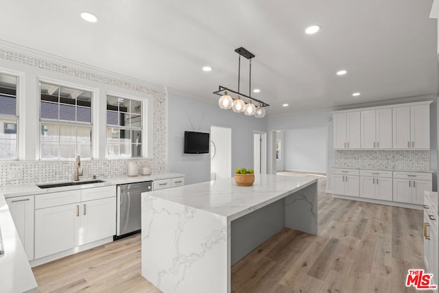 kitchen featuring white cabinetry, stainless steel dishwasher, and a center island