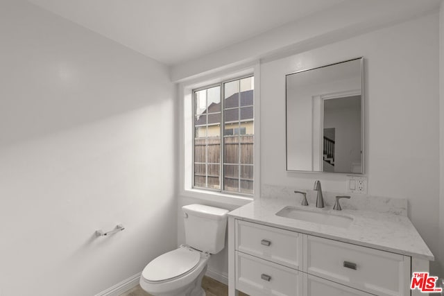 bathroom featuring toilet and vanity