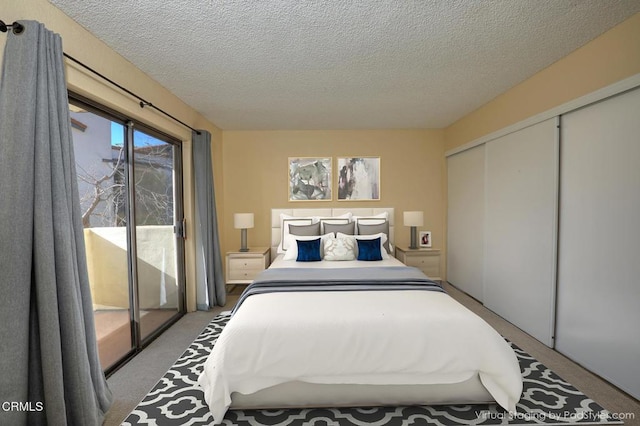 bedroom with a textured ceiling, a closet, access to exterior, and light colored carpet