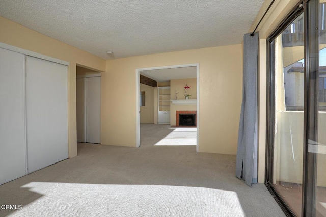 unfurnished bedroom with light colored carpet, a closet, and a textured ceiling