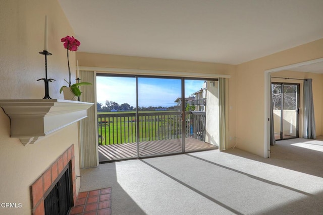 carpeted living room featuring a fireplace