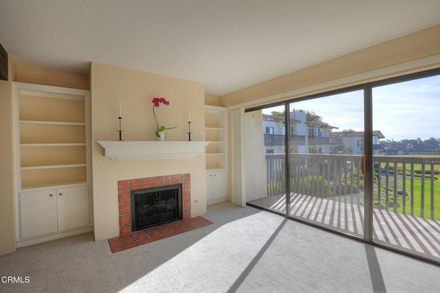 carpeted living room with built in shelves and a brick fireplace