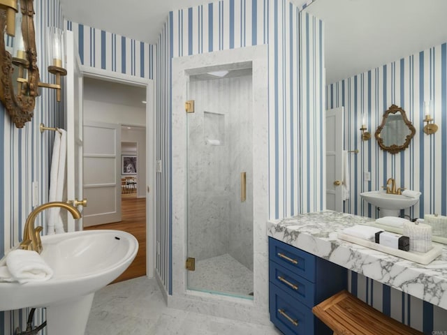 bathroom featuring sink and a shower with shower door