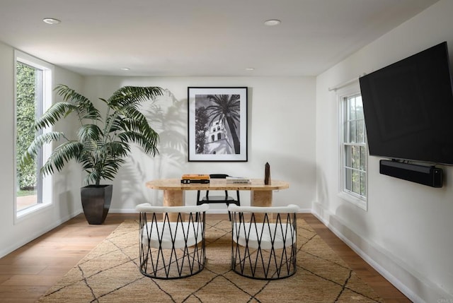 sitting room with light hardwood / wood-style floors and a healthy amount of sunlight