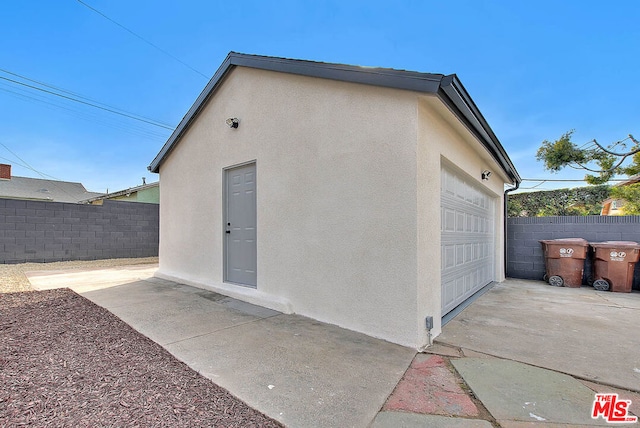 exterior space featuring an outbuilding and a garage