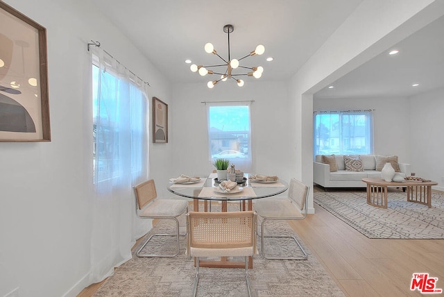 dining area featuring a notable chandelier and light hardwood / wood-style floors