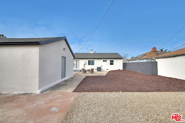 back of house featuring cooling unit and a patio area