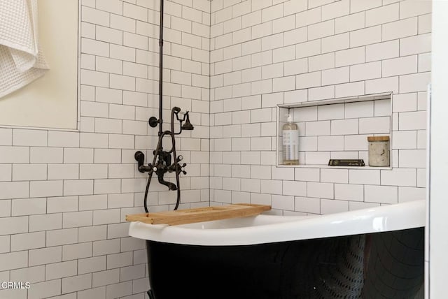 bathroom with a bath and tile walls