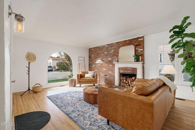 living room with a fireplace and light hardwood / wood-style flooring