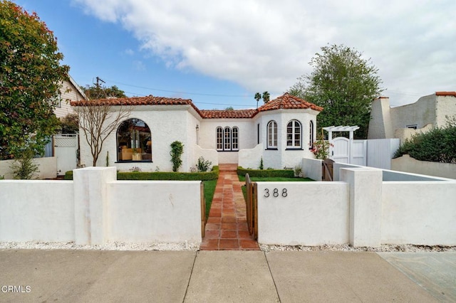 mediterranean / spanish house with a pergola