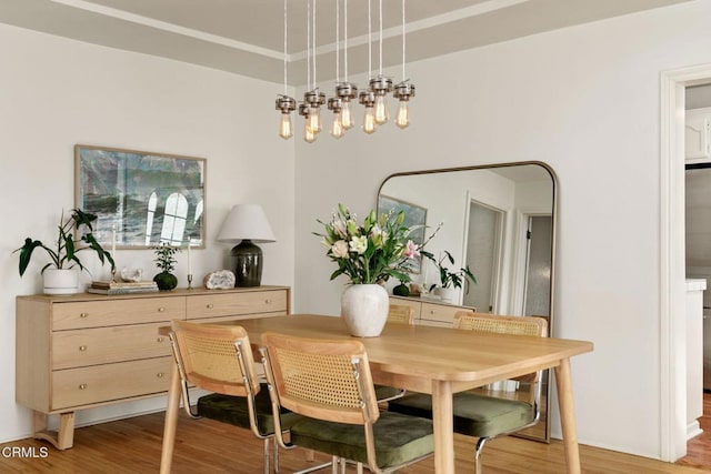 dining space with wood-type flooring