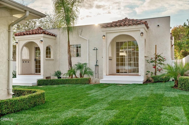 rear view of property with a yard