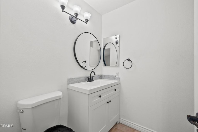 bathroom featuring toilet and vanity