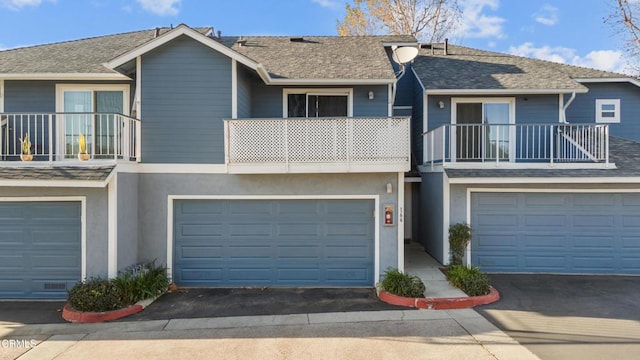 multi unit property with a balcony and a garage