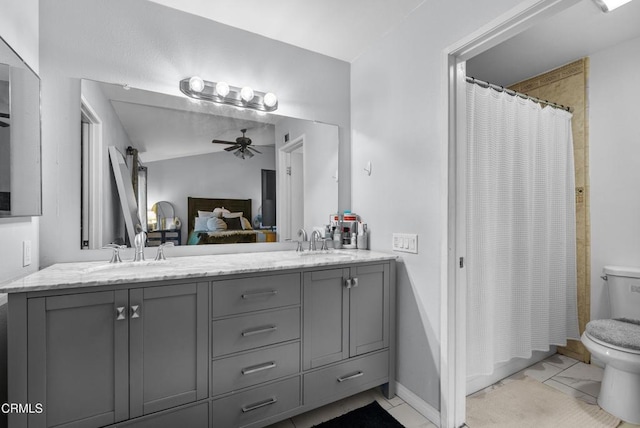 bathroom featuring toilet, ceiling fan, walk in shower, and vanity