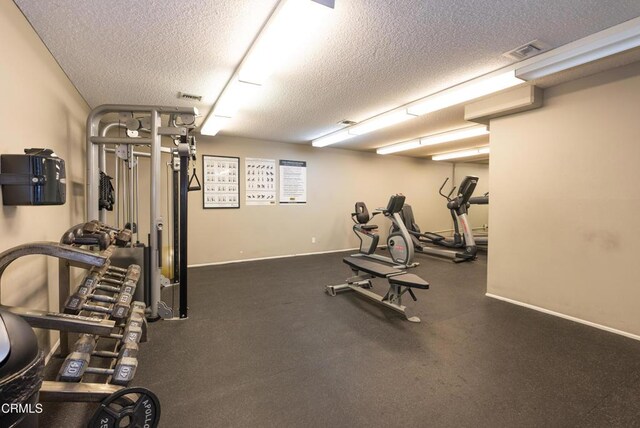 gym featuring a textured ceiling