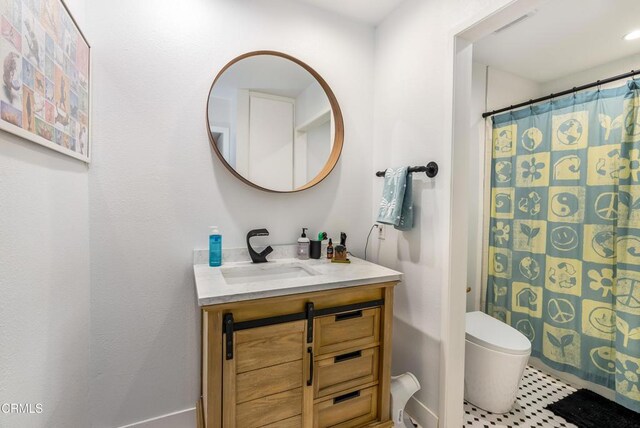 bathroom featuring vanity, curtained shower, and toilet