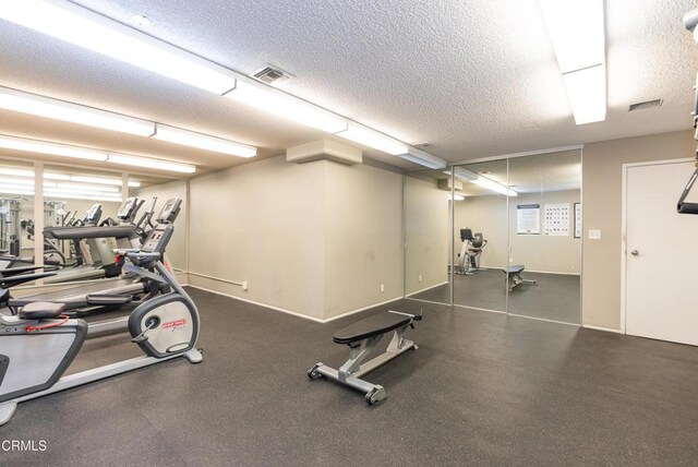 gym featuring a textured ceiling