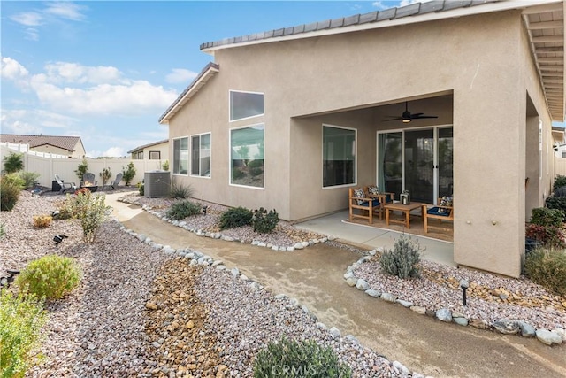 back of house featuring central AC, ceiling fan, and a patio