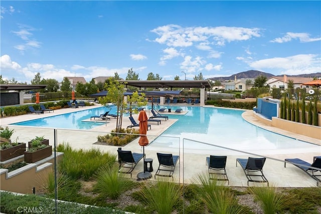 view of pool with a mountain view and a patio area