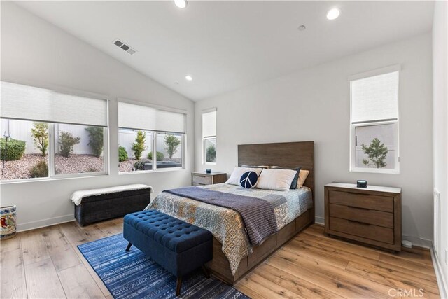 bedroom featuring vaulted ceiling and light hardwood / wood-style flooring