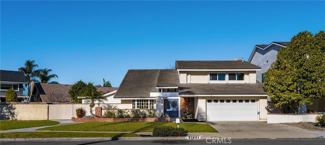 view of front of home with a front yard and a garage