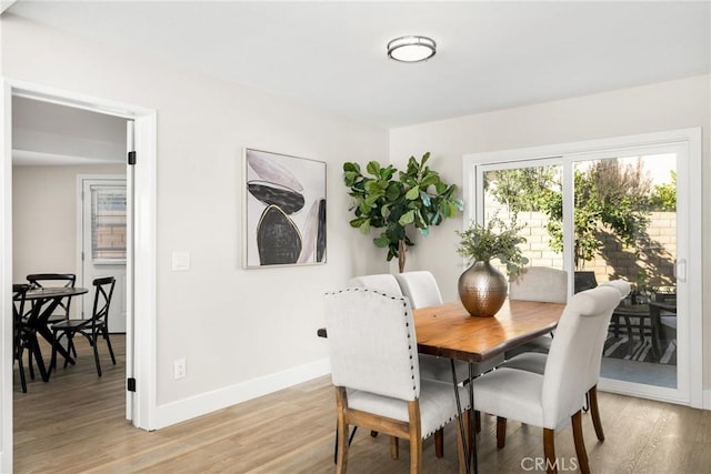 dining area featuring light wood-type flooring