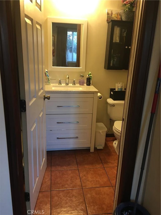 bathroom featuring tile patterned floors, vanity, and toilet