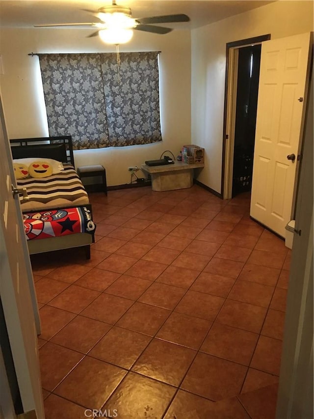 bedroom with ceiling fan and tile patterned floors