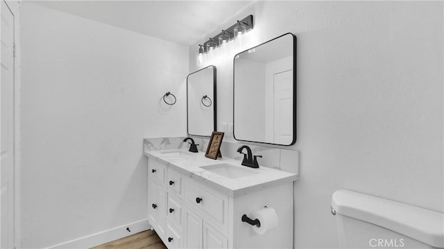 bathroom featuring hardwood / wood-style floors, toilet, and vanity