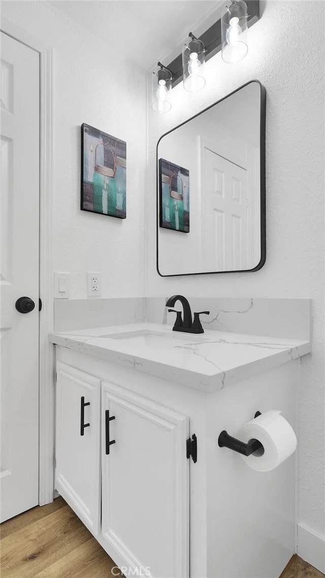 bathroom featuring hardwood / wood-style flooring and vanity