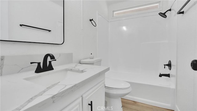 full bathroom with toilet, vanity, tub / shower combination, and hardwood / wood-style floors