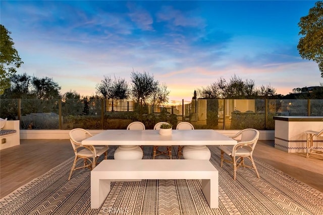 deck at dusk featuring a patio