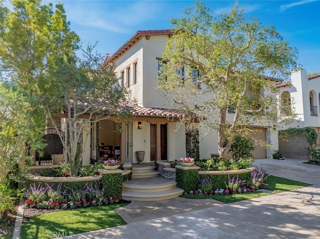 mediterranean / spanish-style home with a garage