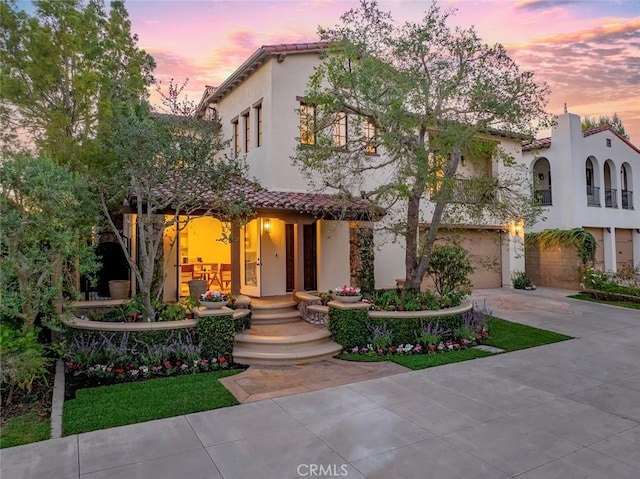 mediterranean / spanish-style home featuring a garage